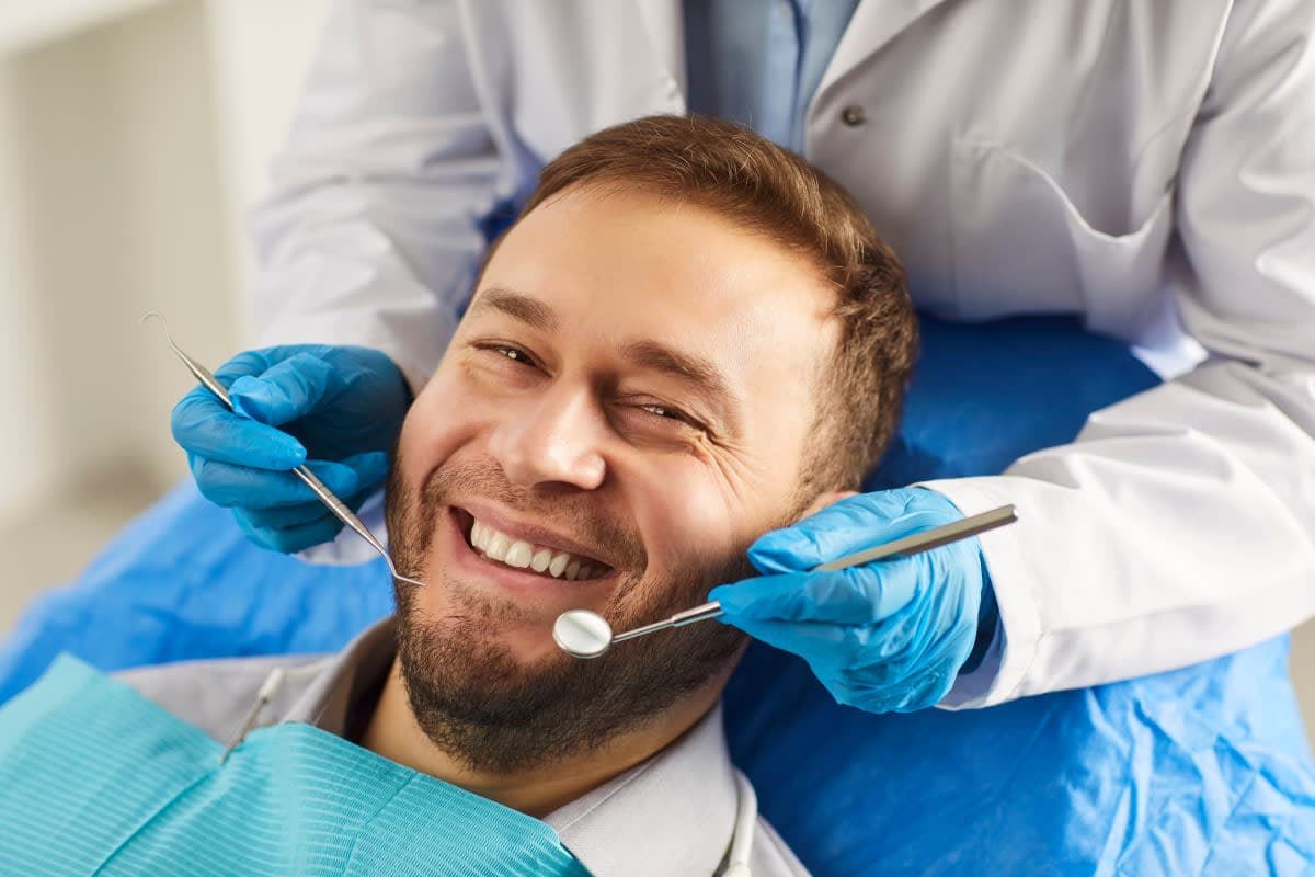Dentist examining a patient's gum health before assessing suitability for orthodontic treatment