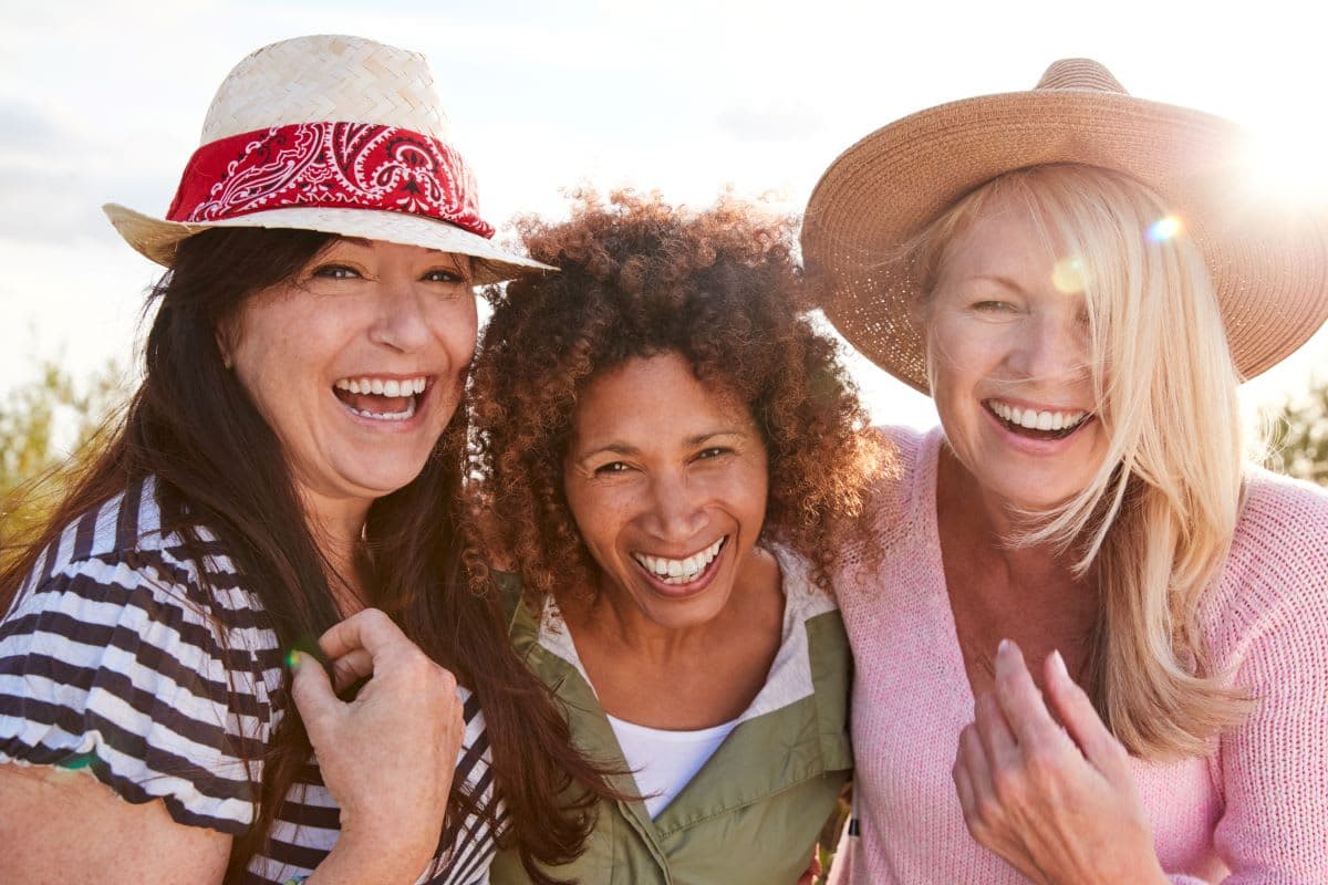 Adult smiling during a dental consultation while discussing missing tooth replacement options