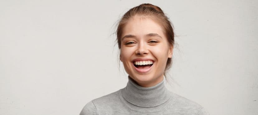 Person smiling confidently after improving their oral health