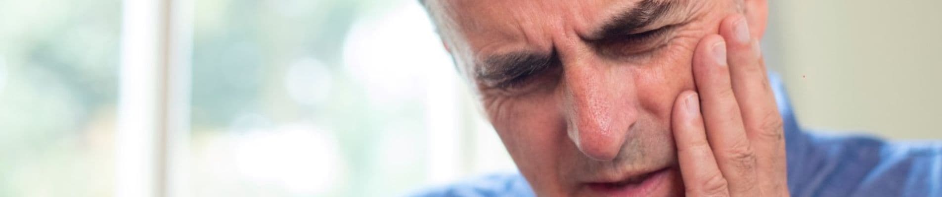 Close-up of a small chip on a front tooth showing the hidden cost of delaying dental repair