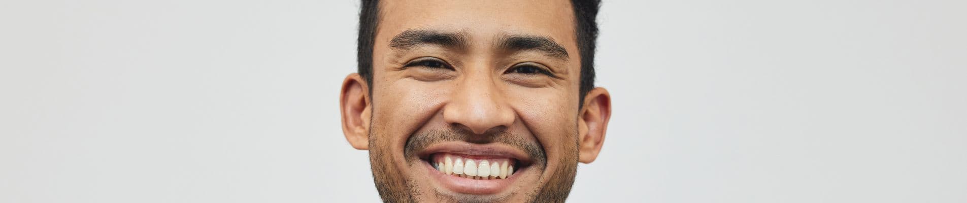 Person experiencing sudden tooth pain holding the side of their jaw